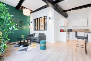 an open living room with a couch and a table at Character apartment in the heart of Old Lille in Lille