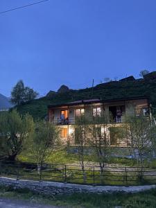 a house on a hill with grass at Hotel SHIBI in Jut'a