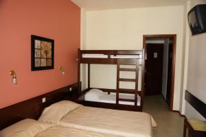 a bedroom with two bunk beds and a staircase at Fiori Hotel in Gouvia