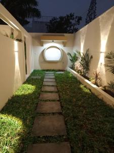 a pathway in a house with a window at Entré Quartier Jack in Cotonou