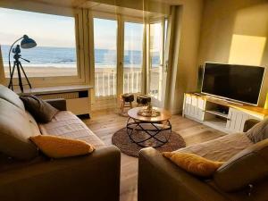 a living room with a view of the ocean at zeedijk westende in Westende