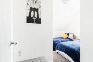 伯明罕的住宿－Sapphire Suite Moseley Mews by StayStaycations，一间卧室配有蓝色的床和黄色枕头