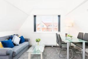 a living room with a couch and a table at Sapphire Suite Moseley Mews by StayStaycations in Birmingham