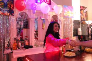 a woman shaking the hand of a man at a bar at Dutchies Hostel in Amsterdam