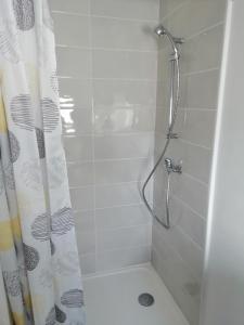 a bathroom with a shower with a shower curtain at Studio 5 proche du port in Cancale