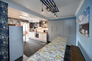 a kitchen with a dining table in a room at Lochans Lodge in Stranraer