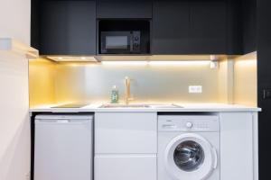 a kitchen with a washing machine and a microwave at Marcq-en-Baroeul - beautiful fully equipped ! 2p in Marquette-lès-Lille