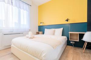 a bedroom with a large white bed and a window at Marcq-en-Baroeul - beautiful fully equipped ! 2p in Marquette-lès-Lille +7 photos