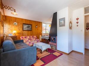 a living room with a couch and a fireplace at Appartement La Clusaz, 2 pièces, 5 personnes - FR-1-304-45 in La Clusaz