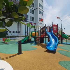 a playground with a blue slide in front of a building at Amber Cove Seaview I MUJI 2BR I Game Room I 3-9pax in Malacca