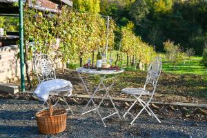 two chairs and a table with a bottle of wine at VAL HILLS Rural Holiday House in Gaj Vrbovečki