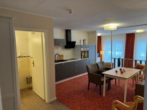 a kitchen and dining room with a table and chairs at Mueßer Hof in Schwerin +8 photos