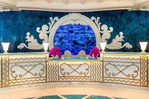 a room with a blue wall and a table with flowers at Grand Hyatt Baha Mar in Nassau