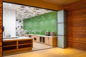 a kitchen with a large green wall at DoubleTree By Hilton Sacramento in Sacramento