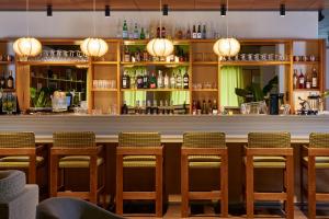 a bar with a row of chairs and a counter at Casa Barbara Nice - Résidence Services in Nice