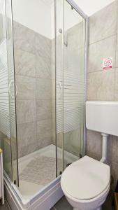 a bathroom with a shower and a toilet at Studio apartman IN Self check in in Osijek