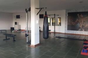a gym with a large tire hanging from a wall at Piemonte Flat Serra Negra in Serra Negra