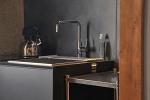 a kitchen with a sink and a counter top at Lhotel de Mai in Tamba-sasayama