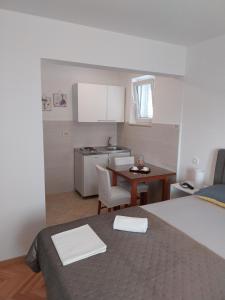 a small room with a kitchen and a table at Apartments Rose Loboja in Makarska