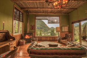 a bedroom with a large bed and a fireplace at Barraco Lodge in Puelo