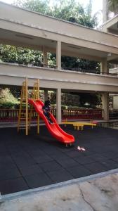 a child on a slide on a playground at Seaview beach Corus Paradise pd in Port Dickson