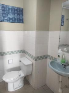 a bathroom with a toilet and a sink at Seaview beach Corus Paradise pd in Port Dickson