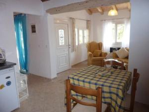 a kitchen and living room with a table and chairs at Nikatsas Cottage No 1 in (( Kerasá ))