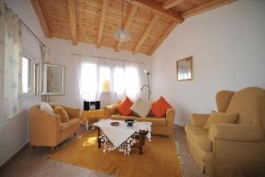 a living room with two couches and a table at Nikatsas Cottage No 1 in (( Kerasá ))
