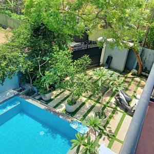 an overhead view of a pool with trees and plants at Osh villa in Hikkaduwa