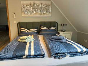 a bed with two twin beds with towels on it at Ferienwohnungen Margot in Iserlohn