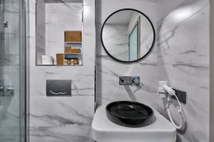 a bathroom with a mirror and a black toilet at Joyway Hotels Istanbul Sultanahmet in Istanbul