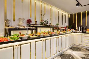 a buffet line with many plates of food at Trademark By Wyndham Operla Airport Hotels Arnavutköy in Arnavutköy