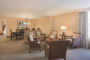 a living room with a couch and chairs at Embassy Suites Savannah Historic District in Savannah