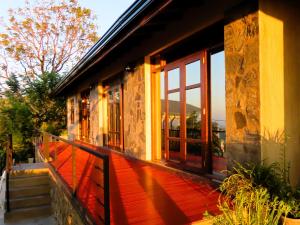 a house with a red deck with a window at Hapu Tales - Private Holiday Villa in Haputale