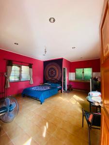 a bedroom with two beds and red walls at Mandala bungalow at Ya Nui beach in Rawai Beach