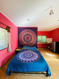 a bedroom with a bed with a colorful wall at Mandala bungalow at Ya Nui beach in Rawai Beach