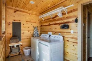 a log cabin with a washer and dryer at Firefly Cabin in Pigeon Forge +41 photos