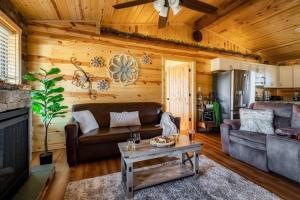 a living room with a couch and a table at Firefly Cabin in Pigeon Forge