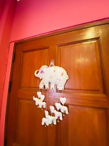a chandelier with a toy elephant hanging from a door at Mandala bungalow at Ya Nui beach in Rawai Beach
