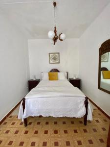 a bedroom with a white bed and a mirror at Casa Ti Barbara 