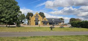 a large building on the side of a road at Relaxing Room With Ensuite Rutland Point in Oakham