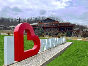 a large sign in front of a building at Deluxe Park Qusar Resort & Spa Hotel in Qusar