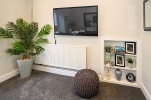a living room with a plant and a mirror at Poet's Cottage Wonderful Cottage In The Welsh Valleys by STAE-Homes in Aberdare