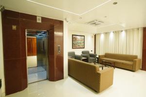 a living room with a couch and a waiting room at HOTEL PRAHLAD INN in Gwalior +24 photos