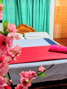 a bedroom with a bed with pink flowers at Udawalawa Safari House in Udawalawe