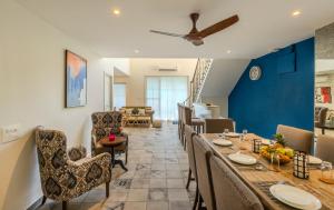 a dining room with a long table and chairs at Casa Amour by Hireavilla - 5BR w Pvt Pool in Siolim in Siolim