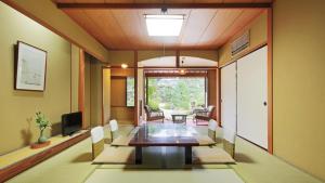 a dining room with a long table and chairs at Konya in Matsue