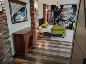 a bedroom with a bed and a brick wall at Harmonica PREMIUM in Nowy Sącz