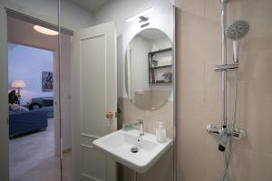 a bathroom with a sink and a shower with a mirror at Apartamento Castilla 61 by SHS in Seville