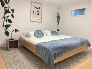 a bedroom with a bed with a blue blanket on it at Big Modern Space 75sqm in Herborn